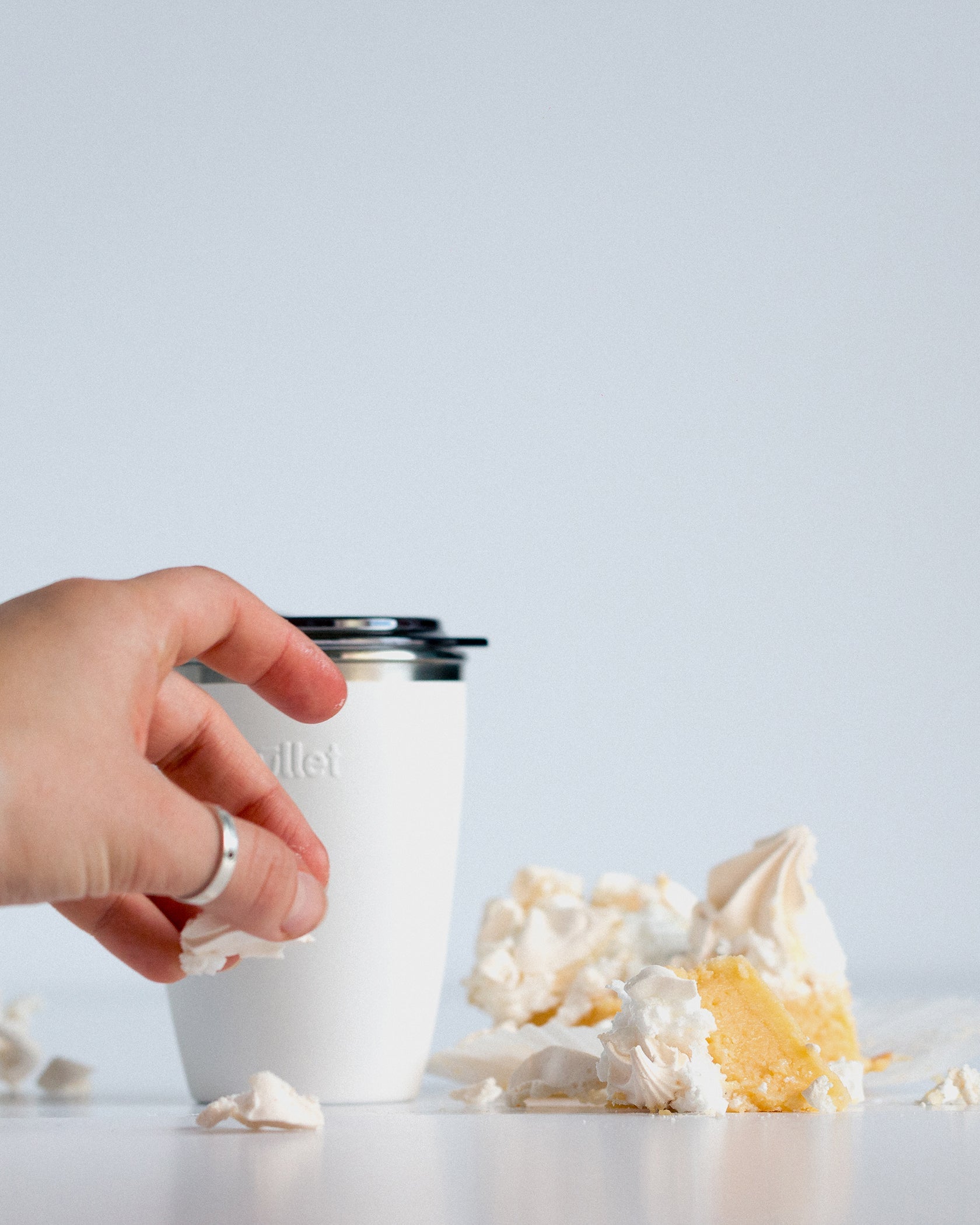 8oz white bullet cup next to a lemon meringue slice