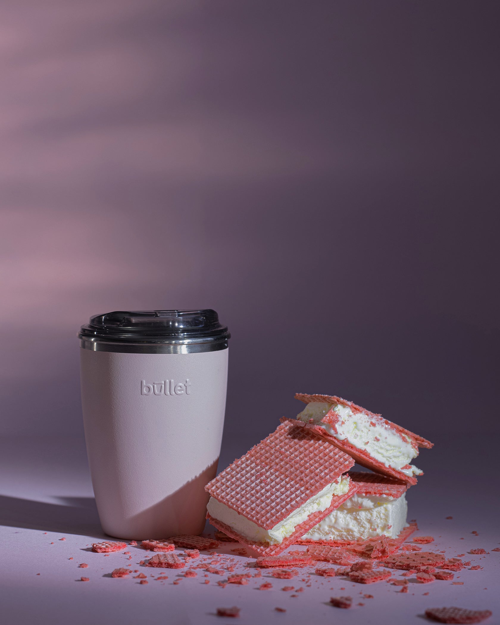 pink reusable bullet cup next to a vanilla ice-cream slice