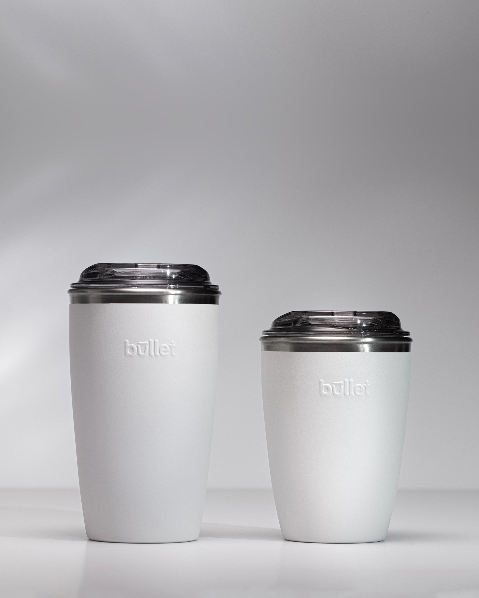side by side comparison of an 8oz and 12oz white bullet cup