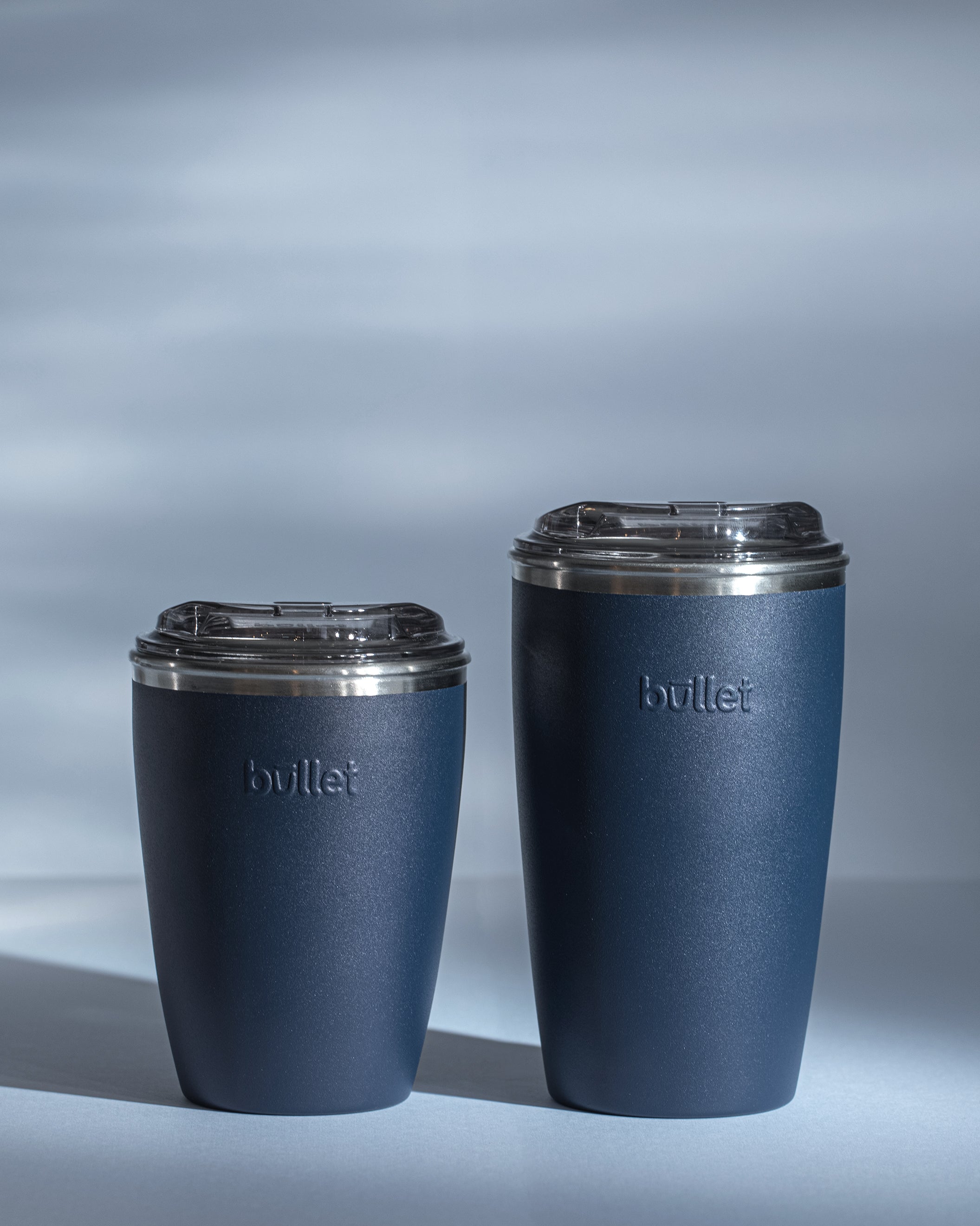 side by side comparison of an 8oz and 12oz blue bullet cup